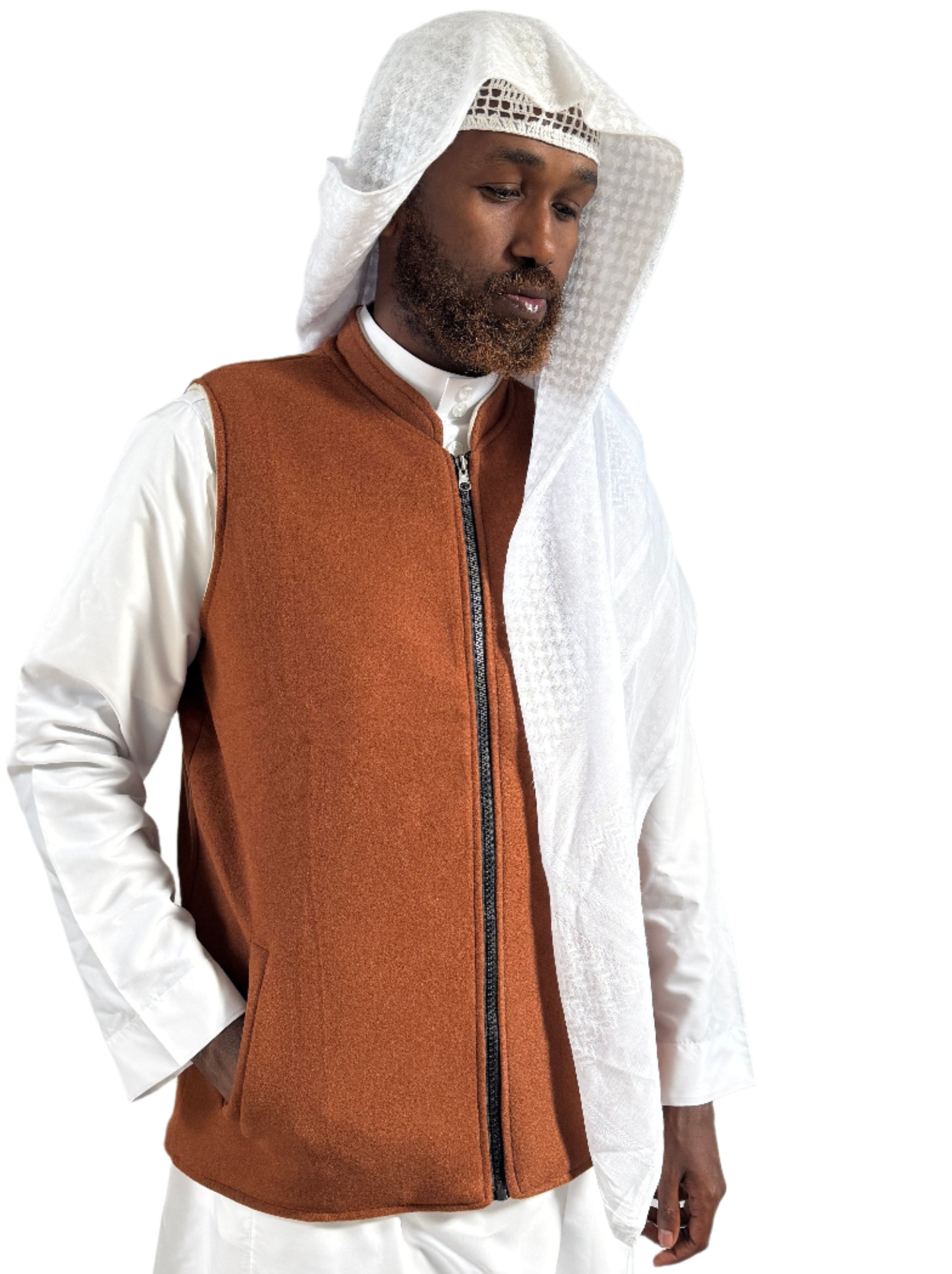 Person wearing a brown vest over a white outfit with a white hood.